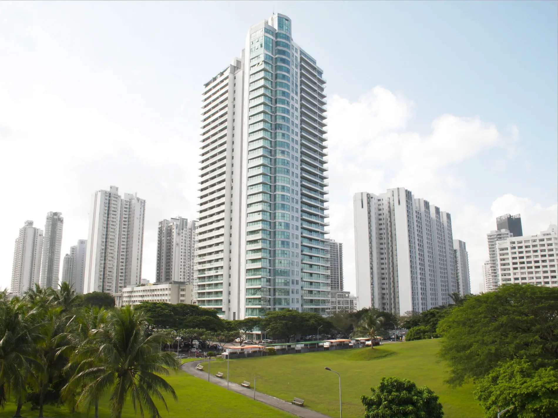 Modern residential towers in Panama City seen from a green park